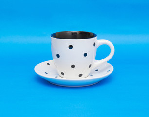 White cup isolated on blue background
