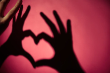 Obraz premium Hand shaped heart on lilac background