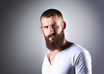 Fototapeta premium Portrait of handsome man standing, isolated on grey background