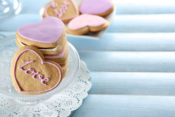 Pile of love cookies on blue wooden table background