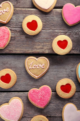 Assortment of love cookies on wooden background