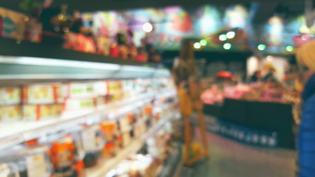 Supermarket store interior with customers, blurred background
