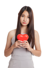Beautiful young Asian woman with red heart