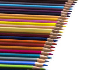 colored pencils on a blank sheet of paper, ready to be used in design
