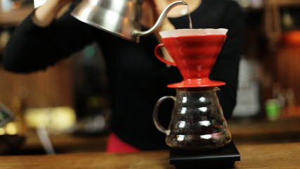  Pour over coffee brewing method whole process by barista girl. Barista girl pours water into the filter