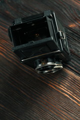 The old film camera on the old wooden table.