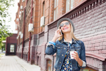 Fototapeta premium Young woman walking down the street