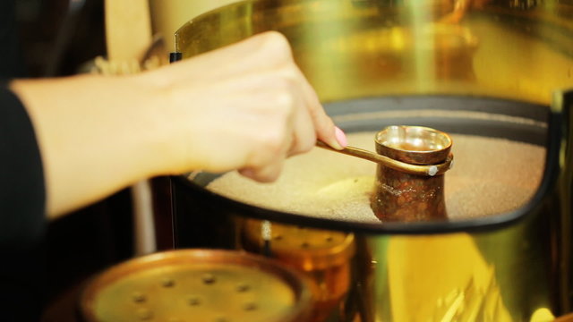  Metal cezve (ibrik) in hot sand during coffee preparation