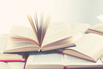 Many open books on light background