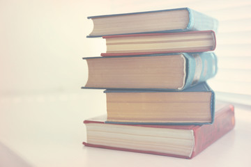 Books on white windowsill, close up