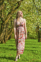 Portrait of Sensual Smiling Blond Lady Enjoying in Spring Forest