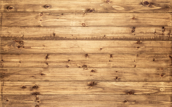 Light brown wood texture background viewed from above. The wooden planks are stacked horizontally and have a worn look. This surface would be great as design element for a wall, floor, table etc…