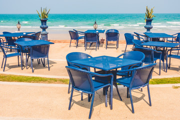 Empty table and chair around beach background