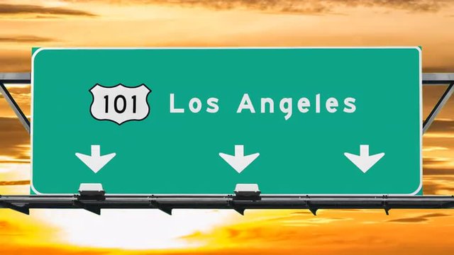 Los Angeles 101 freeway sign with sunrise sky time lapse.