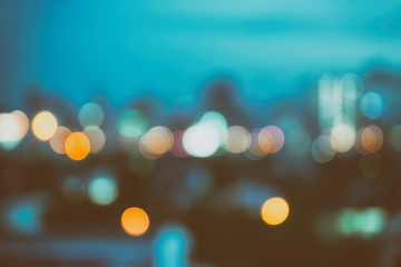 abstract background with bokeh defocused lights and shadow from cityscape at night, vintage or retro color tone 