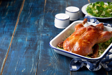 Roast duck in enamel baking dish, selective focus