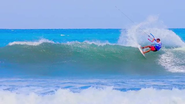 Extreme sports video background. Kitesurfing athlete rides on high waves on sea