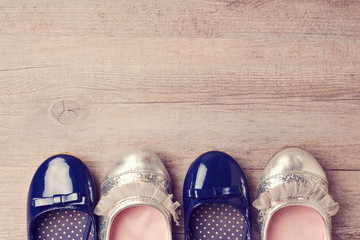 Young girl shoes on wooden background. Retro filter effect