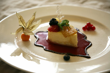 exquisite fruit dessert in the form of a sailing boat with gold