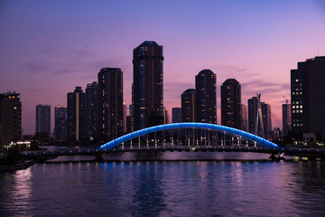 Panoramic view of Tokyo High rise condominium and Sumida river with Eitai Bridge at magic hour
