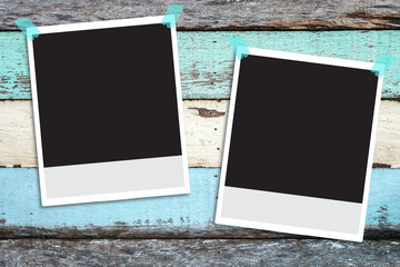 Polaroid photo frame on wood background