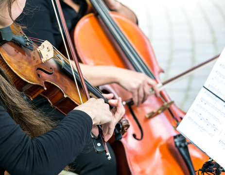 Street Musicians Playing On Violin And Cello