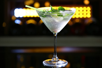 Glass of cocktail on bar background