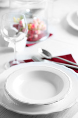 Table set at restaurant on light background