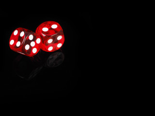 Two red casino dices with  reflection . black background