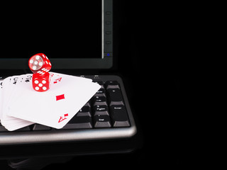 Cards, dice beside the keyboard. online card games concept