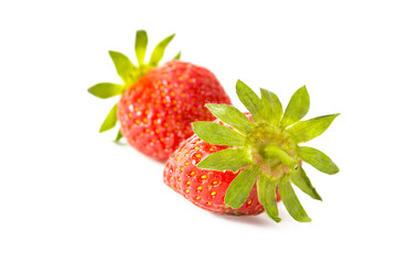 Two fresh strawberries close up on white background.