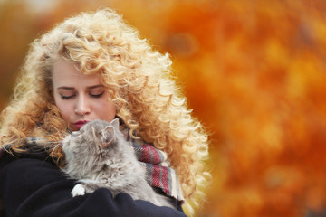 Young woman and cat in the park