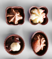 Delicious chocolate candies on white background