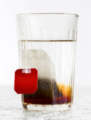 Faceted glass of boiled water and tea bag © sv_production