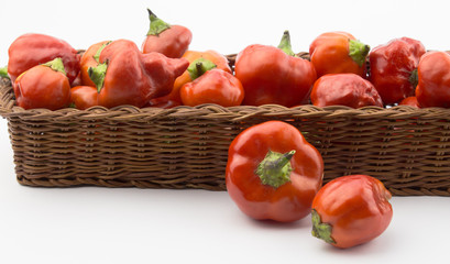 Fototapeta na wymiar Basket of red chilis isolated on white