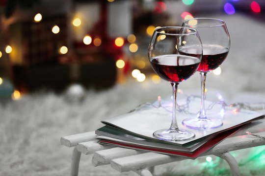 Two glasses of red wine on Christmas decoration background