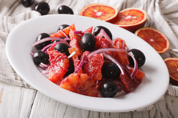 Delicious Sicilian orange salad and ingredients close-up. Horizontal
