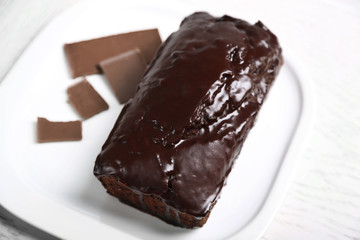 Chocolate cake with icing on white table