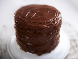 Chocolate cake on a plate on unfocused background