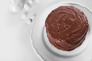 Tasty chocolate cake on light background