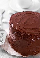 Chocolate cake with blade on a wooden table background