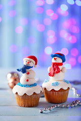 Christmas cupcakes with lights on background