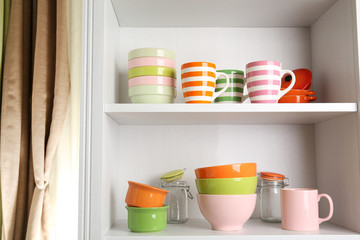 Tableware on shelves in the kitchen cupboard