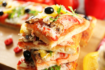 Pieces of delicious pizza on the table, close-up