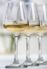 Glasses of white wine on table closeup