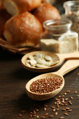 Composition of seeds and buns on wooden table background, closeup