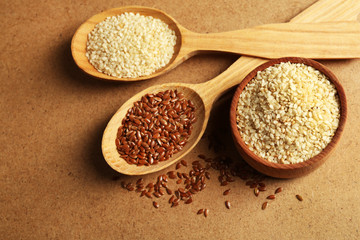 Sesame and flax seeds on beige background, closeup