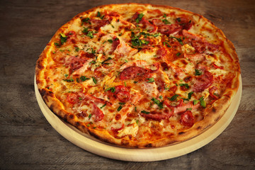 Delicious pizza on wooden table