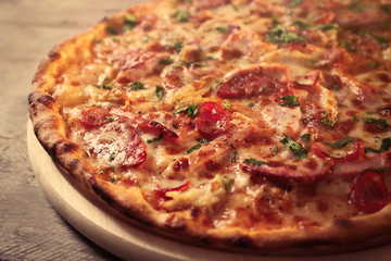 Delicious pizza on wooden table, close up