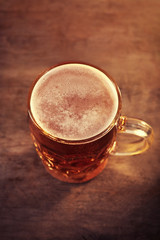 Glass of beer on wooden table